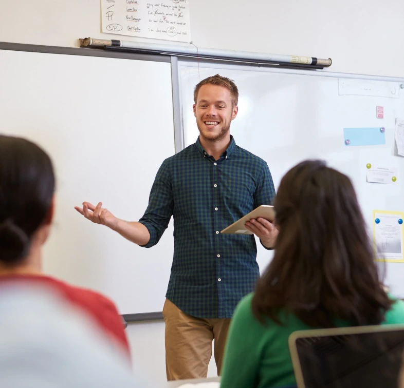 Young male teacher holding a lesson for secondary pupils